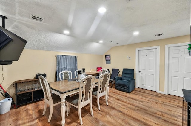 848 Dexter St, Central Falls, RI 02863 - dining space featuring light wood-type flooring, recessed lighting, lofted ceiling, a textured ceiling, and baseboards
