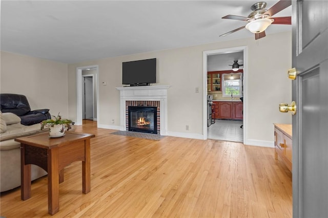199 Vaughn Ave, Warwick, RI 02886 - living room with ceiling fan, a fireplace, light wood-type flooring, and baseboards