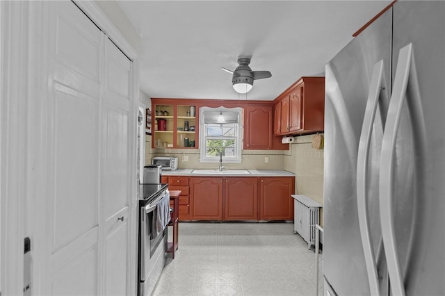 199 Vaughn Ave, Warwick, RI 02886 - kitchen featuring stainless steel appliances, a sink, ceiling fan, light countertops, and light flooring