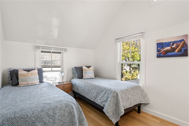 14 Robinson St, Narragansett, RI 02882 - bedroom featuring wood finished floors, multiple windows, vaulted ceiling, and baseboards