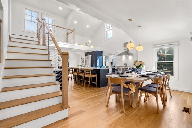 14 Robinson St, Narragansett, RI 02882 - dining space with high vaulted ceiling, light wood finished floors, stairs, recessed lighting, and a chandelier