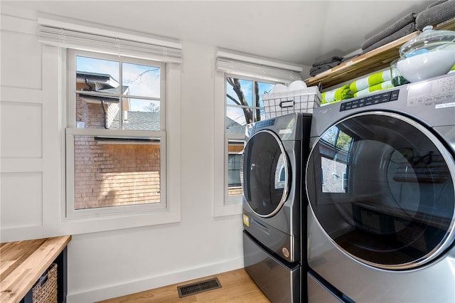 14 Robinson St, Narragansett, RI 02882 - washroom with washing machine and dryer, baseboards, and light wood-style flooring