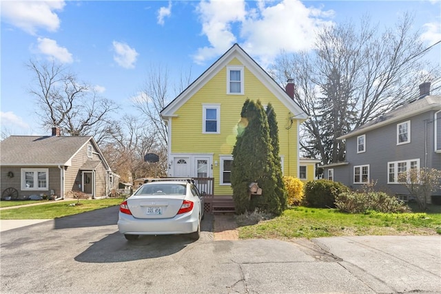 66 Earl Ave, East Providence, RI 02915 - view of front facade with a front yard and a chimney
