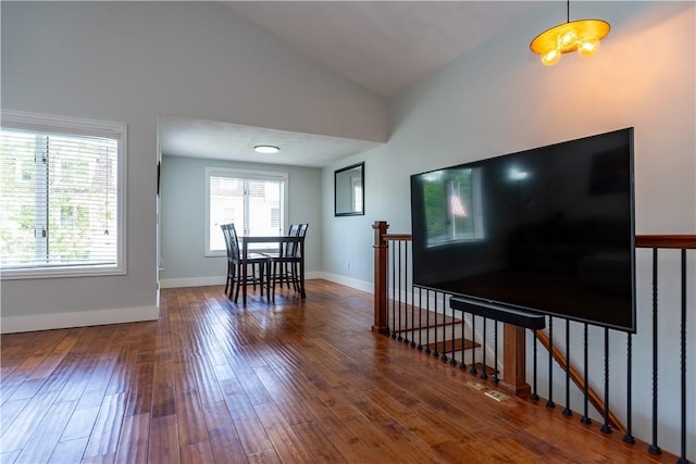 3976 Post Rd, Warwick, RI 02886 - living room with wood finished floors, lofted ceiling, and baseboards
