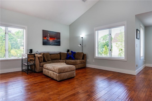 3976 Post Rd, Warwick, RI 02886 - living room featuring baseboards, wood-type flooring, and vaulted ceiling