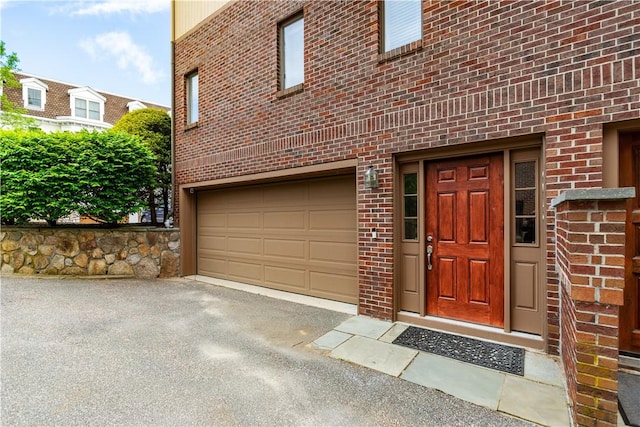 3976 Post Rd, Warwick, RI 02886 - entrance to property with brick siding, a garage, and asphalt driveway