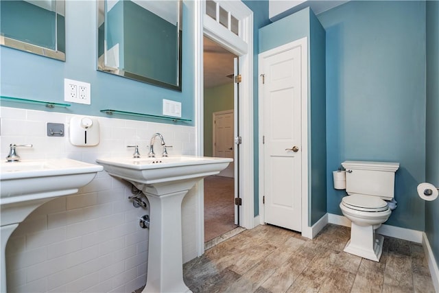 3976 Post Rd, Warwick, RI 02886 - bathroom featuring toilet, a sink, wood finished floors, and baseboards