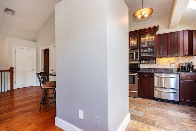 3976 Post Rd, Warwick, RI 02886 - bar area with vaulted ceiling, appliances with stainless steel finishes, backsplash, baseboards, and hanging light fixtures