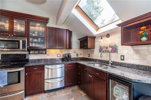 3976 Post Rd, Warwick, RI 02886 - kitchen featuring stainless steel appliances, a sink, lofted ceiling, a skylight, and stone finish floors