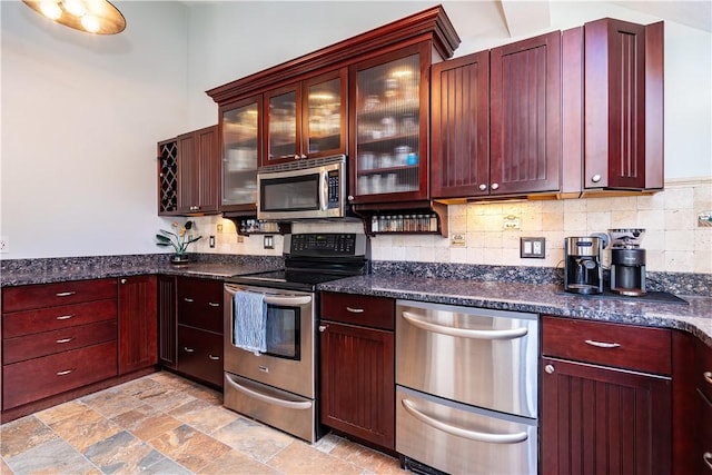 3976 Post Rd, Warwick, RI 02886 - kitchen featuring appliances with stainless steel finishes, backsplash, and dark brown cabinets