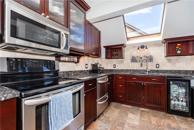 3976 Post Rd, Warwick, RI 02886 - kitchen with appliances with stainless steel finishes, wine cooler, a sink, stone tile flooring, and tasteful backsplash