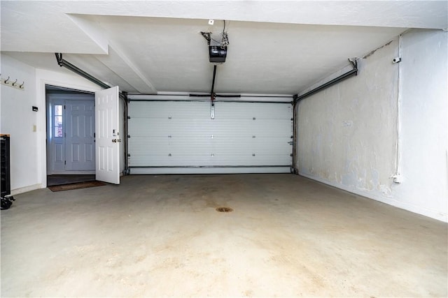 3976 Post Rd, Warwick, RI 02886 - garage featuring a garage door opener and baseboards