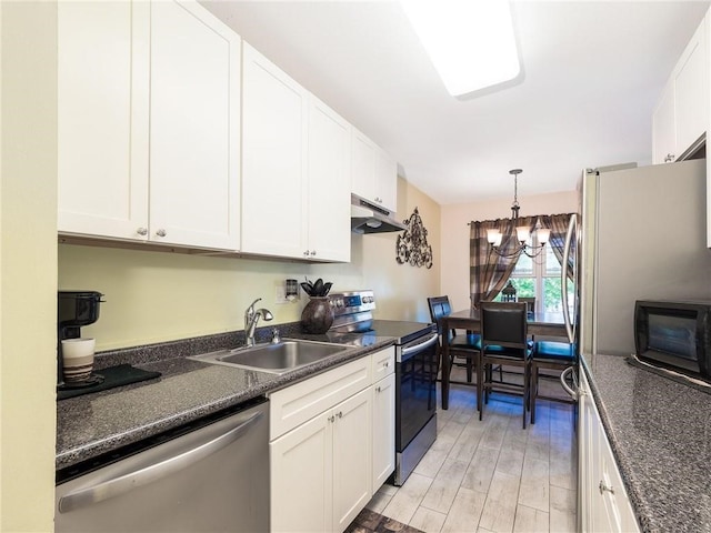 23 Bullocks Point Ave Unit 2/4C, East Providence, RI 02915 - kitchen featuring appliances with stainless steel finishes, under cabinet range hood, a sink, a chandelier, and white cabinets