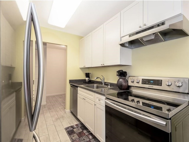23 Bullocks Point Ave Unit 2/4C, East Providence, RI 02915 - kitchen featuring stainless steel appliances, under cabinet range hood, a sink, dark countertops, and white cabinetry