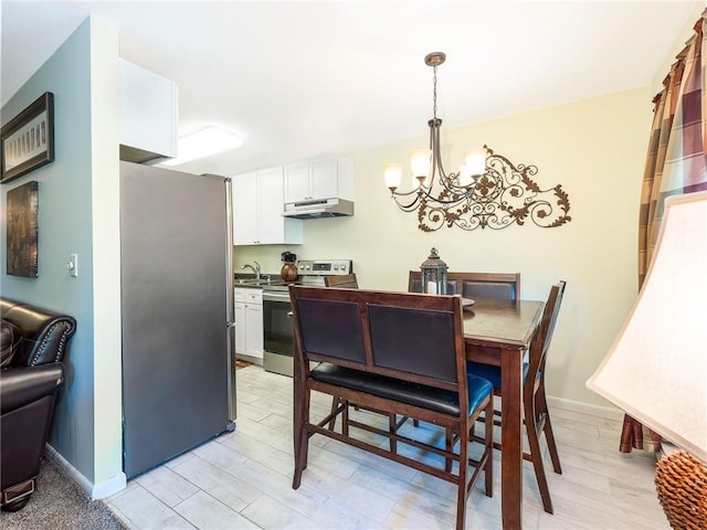 23 Bullocks Point Ave Unit 2/4C, East Providence, RI 02915 - dining space with a chandelier, baseboards, and light wood-style flooring