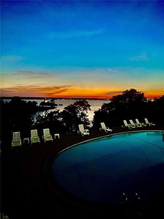 23 Bullocks Point Ave Unit 2/4C, East Providence, RI 02915 - pool at dusk featuring a water view and a community pool