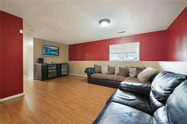 29 Valley View Dr, Cranston, RI 02921 - living area with wood finished floors, a textured ceiling, beverage cooler, and baseboards