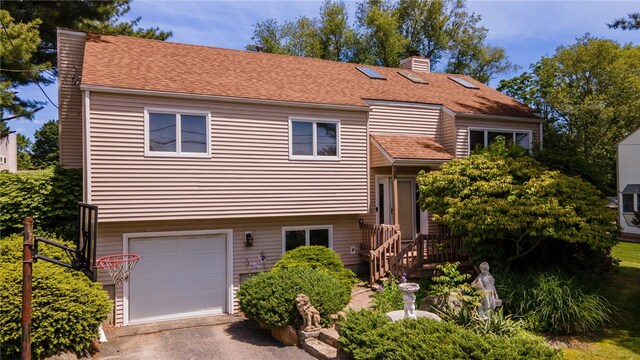 29 Valley View Dr, Cranston, RI 02921 - tri-level home featuring a chimney, an attached garage, asphalt driveway, a shingled roof, and a wooden deck