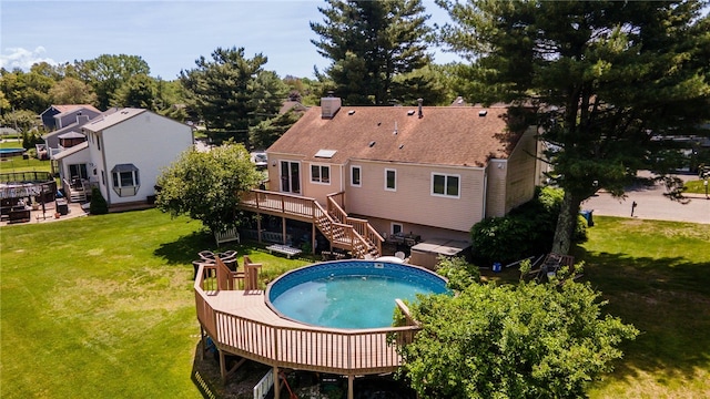 29 Valley View Dr, Cranston, RI 02921 - rear view of property featuring a deck, stairway, a chimney, a yard, and an outdoor pool