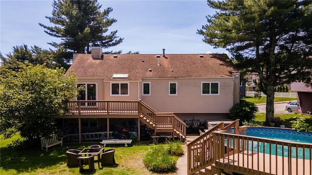 29 Valley View Dr, Cranston, RI 02921 - rear view of house featuring stairs, a wooden deck, an outdoor pool, a chimney, and a shingled roof