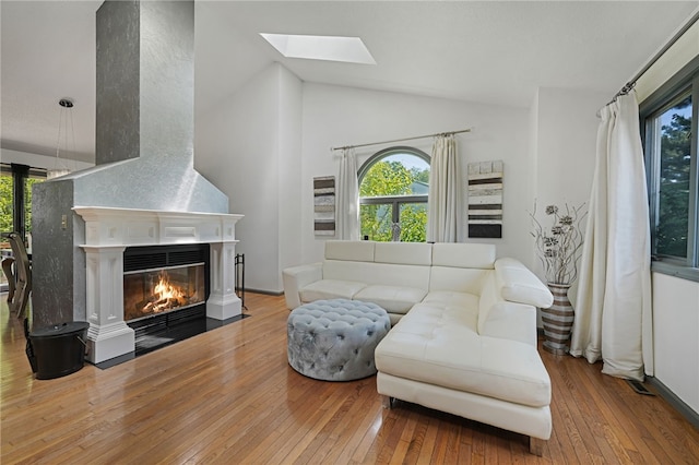 29 Valley View Dr, Cranston, RI 02921 - living area with hardwood / wood-style floors, a skylight, high vaulted ceiling, and a fireplace with flush hearth