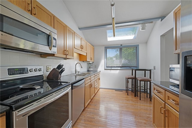 29 Valley View Dr, Cranston, RI 02921 - kitchen featuring stainless steel appliances, dark countertops, a sink, decorative backsplash, and lofted ceiling