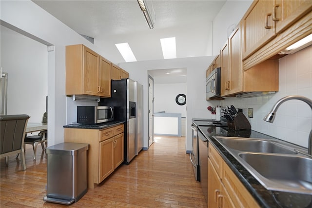 29 Valley View Dr, Cranston, RI 02921 - kitchen featuring a sink, stainless steel appliances, a skylight, tasteful backsplash, and light wood finished floors