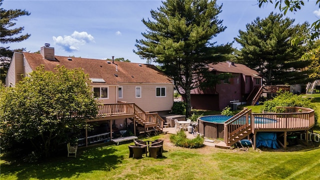 29 Valley View Dr, Cranston, RI 02921 - back of property featuring stairway, a deck, a chimney, and a lawn