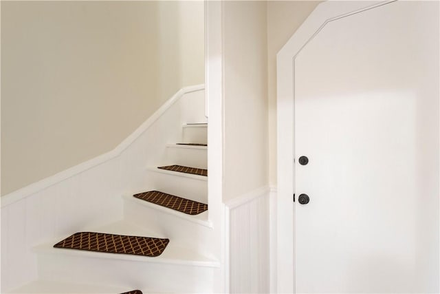 9 Woodbine St, Providence, RI 02906 - staircase featuring a wainscoted wall and a decorative wall