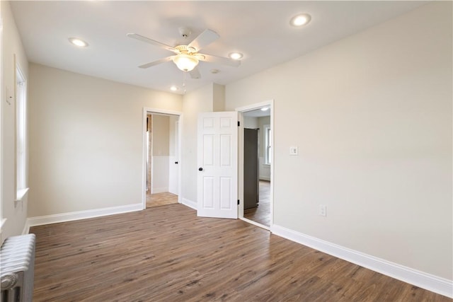 9 Woodbine St, Providence, RI 02906 - unfurnished bedroom with radiator, baseboards, wood finished floors, recessed lighting, and a closet