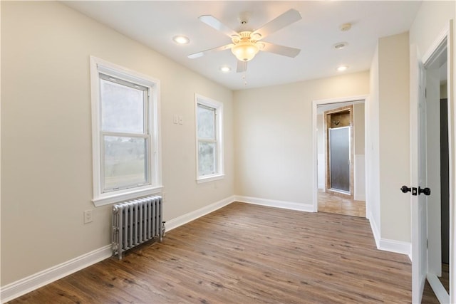 9 Woodbine St, Providence, RI 02906 - unfurnished room featuring radiator, wood finished floors, baseboards, recessed lighting, and a ceiling fan
