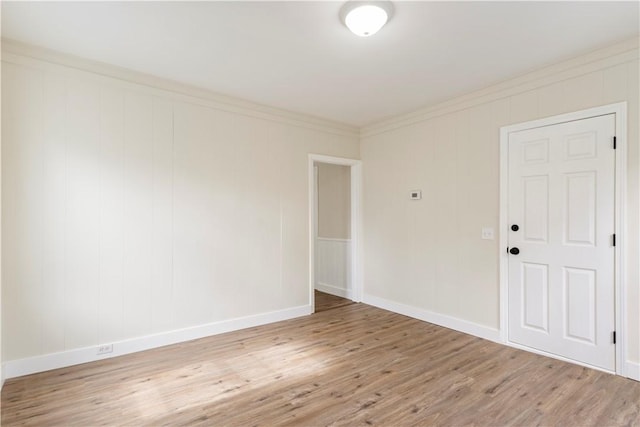 9 Woodbine St, Providence, RI 02906 - empty room featuring light wood-style flooring, ornamental molding, and baseboards