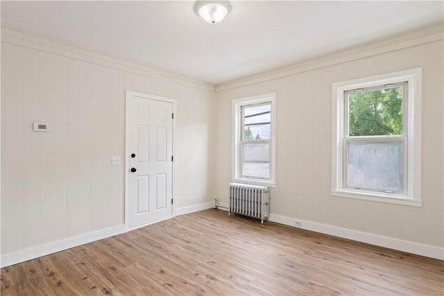 9 Woodbine St, Providence, RI 02906 - unfurnished room featuring radiator, healthy amount of natural light, wood finished floors, and crown molding