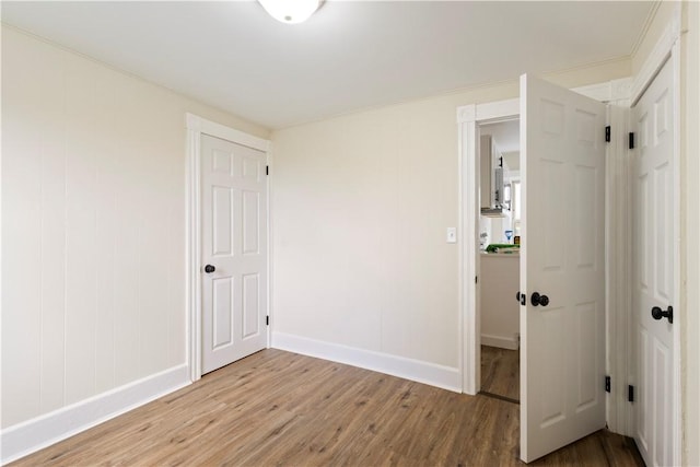 9 Woodbine St, Providence, RI 02906 - unfurnished bedroom featuring light wood-type flooring, baseboards, and a closet