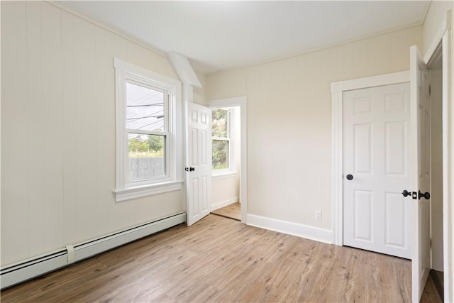 9 Woodbine St, Providence, RI 02906 - empty room featuring baseboard heating, wood finished floors, and baseboards