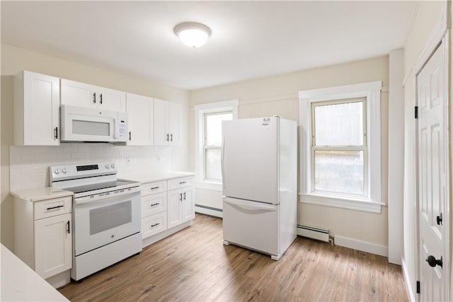 9 Woodbine St, Providence, RI 02906 - kitchen with white appliances, a baseboard heating unit, and healthy amount of natural light