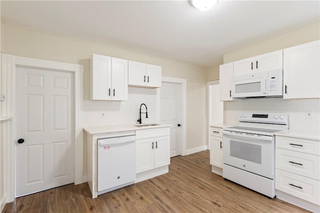 9 Woodbine St, Providence, RI 02906 - kitchen featuring white appliances, a sink, decorative backsplash, and white cabinetry