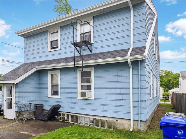 106 Baxter St, Pawtucket, RI 02861 - back of property featuring a shingled roof and cooling unit