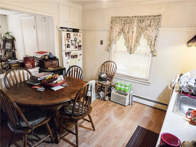 106 Baxter St, Pawtucket, RI 02861 - dining area with light wood-type flooring, a baseboard radiator, and ornamental molding