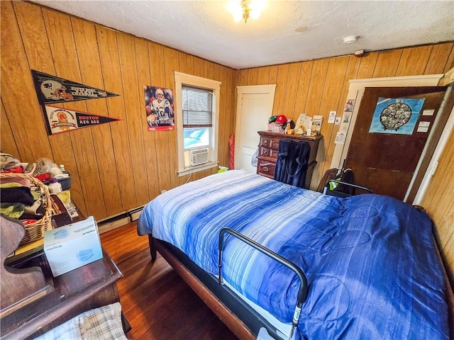 106 Baxter St, Pawtucket, RI 02861 - bedroom with wooden walls, wood finished floors, a baseboard heating unit, and cooling unit