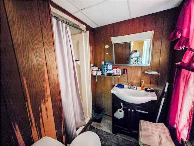 106 Baxter St, Pawtucket, RI 02861 - bathroom with curtained shower, wooden walls, vanity, and toilet