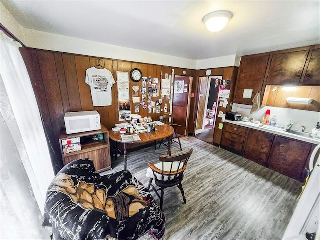 106 Baxter St, Pawtucket, RI 02861 - kitchen with white microwave, wood finished floors, light countertops, and wooden walls