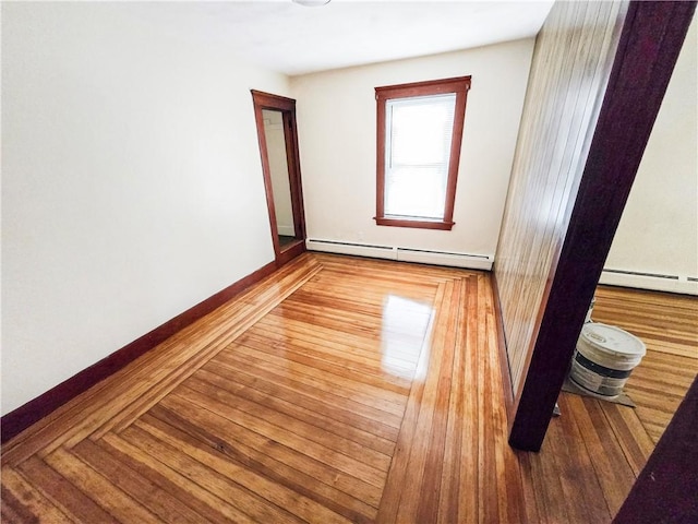 106 Baxter St, Pawtucket, RI 02861 - unfurnished room featuring a baseboard heating unit, wood finished floors, and baseboards