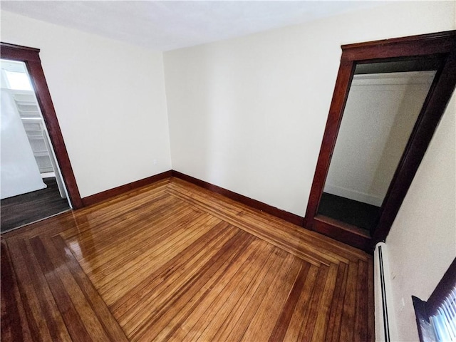 106 Baxter St, Pawtucket, RI 02861 - unfurnished room with a baseboard radiator, wood finished floors, and baseboards