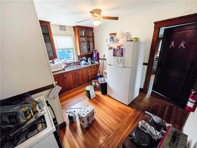 106 Baxter St, Pawtucket, RI 02861 - kitchen featuring white appliances, ceiling fan, brown cabinets, glass insert cabinets, and a sink