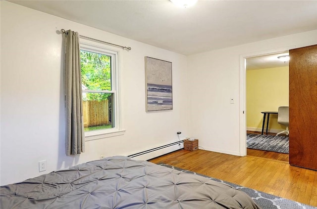 9 Roberta Dr, Barrington, RI 02806 - bedroom featuring a baseboard heating unit, wood finished floors, and baseboards