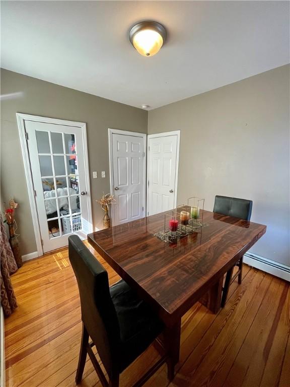 86 Edgemere Ave, Providence, RI 02909 - dining space with light wood-style flooring, a baseboard radiator, and baseboards