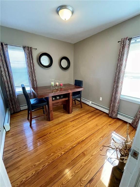 86 Edgemere Ave, Providence, RI 02909 - dining room featuring plenty of natural light, light wood finished floors, and baseboard heating