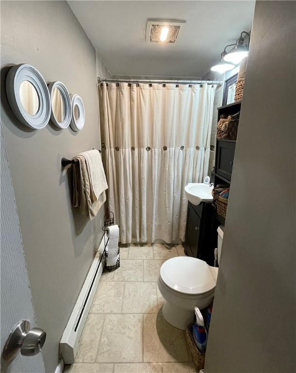86 Edgemere Ave, Providence, RI 02909 - bathroom with baseboard heating, stone tile flooring, toilet, and a shower with curtain