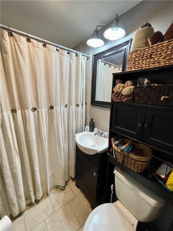 86 Edgemere Ave, Providence, RI 02909 - full bathroom featuring toilet, vanity, and a shower with shower curtain